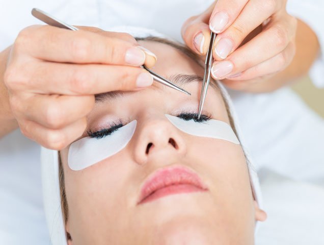 Woman getting eyelash extensions