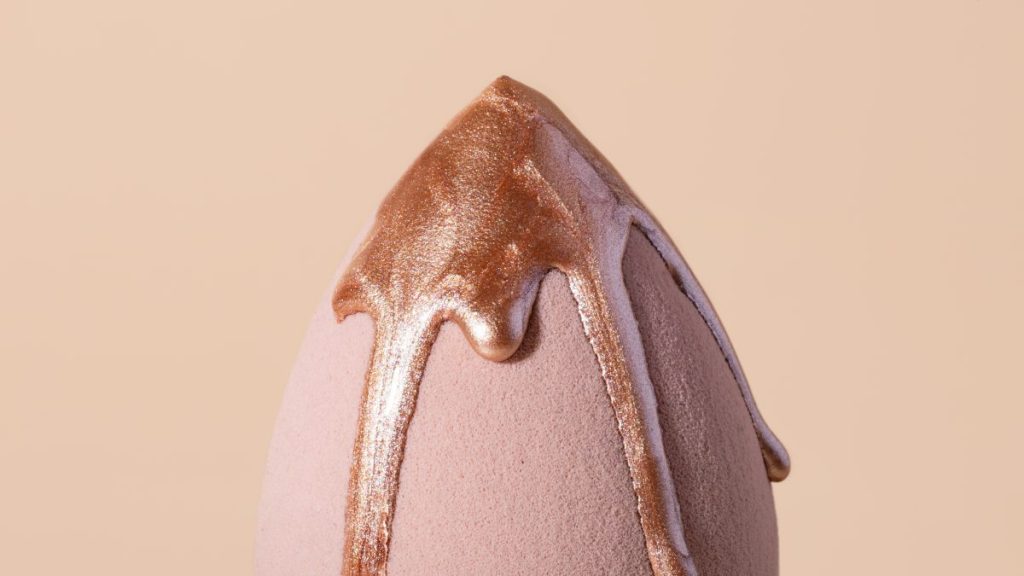 Beauty blender with dripping bronzer on it