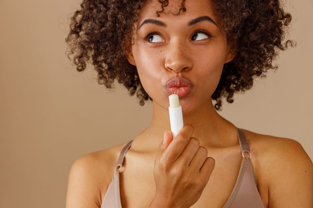 Girl posing with a lip balm