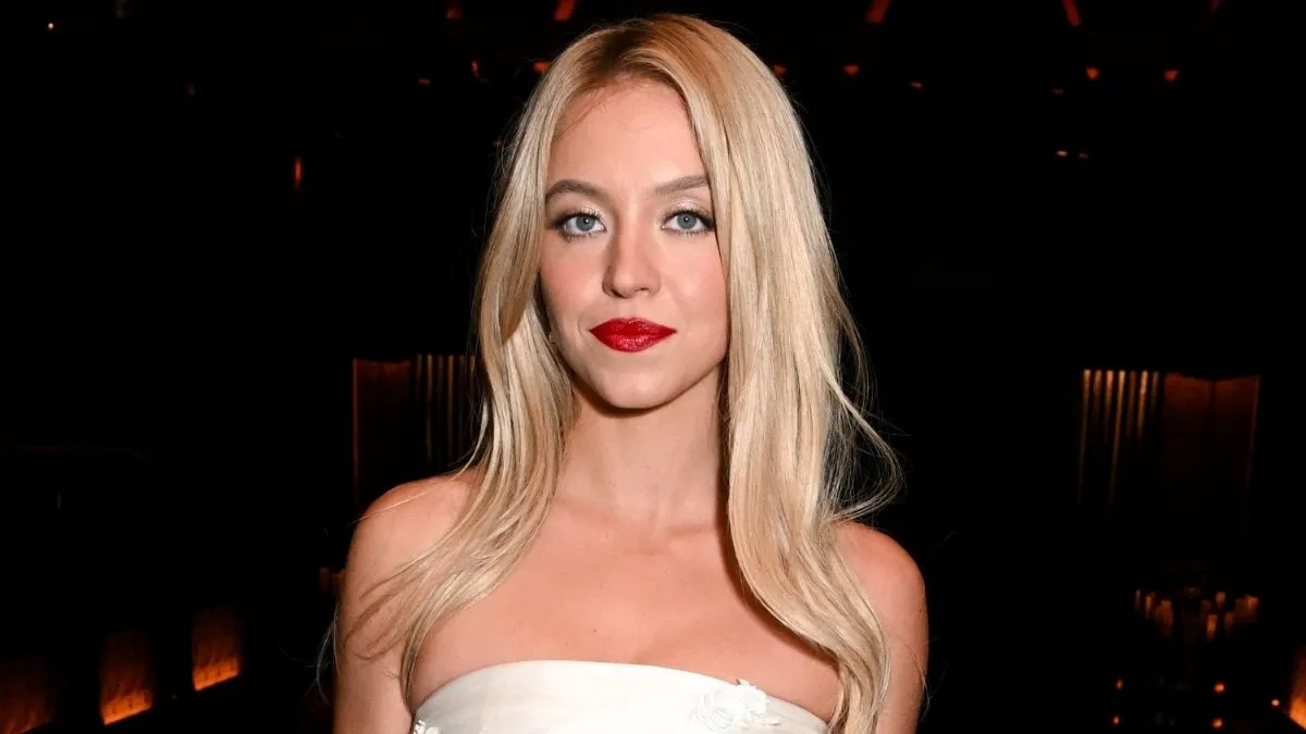 Sydney Sweeney posing in SYRN campaign wearing white corset and lace bikini bottom